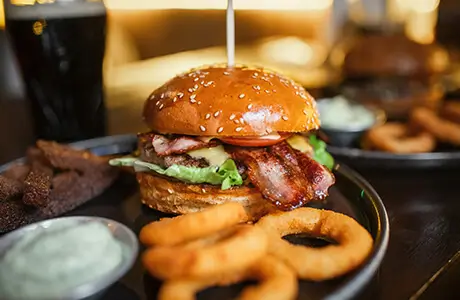 a burger with onion rings