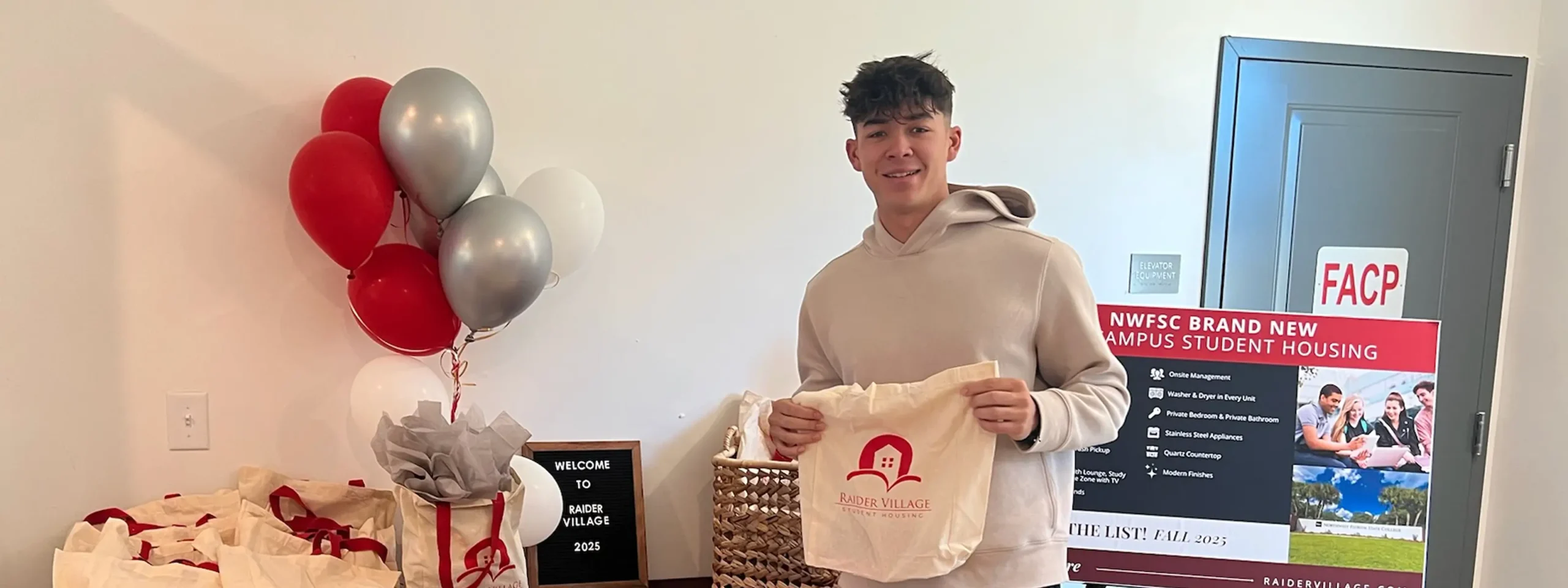 a resident holding a Raider Village tote bag